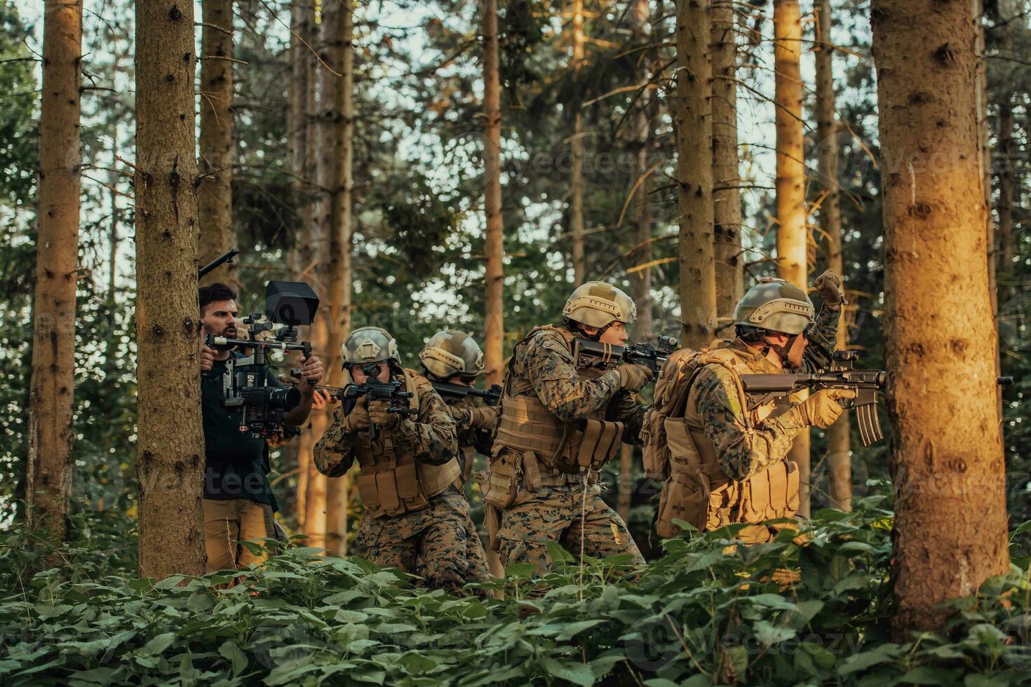 Videographer with Professional Movie Video Camera Gimbal Stabilizing Equipment Taking Action Shoot of Soldiers in Action in Forest photo