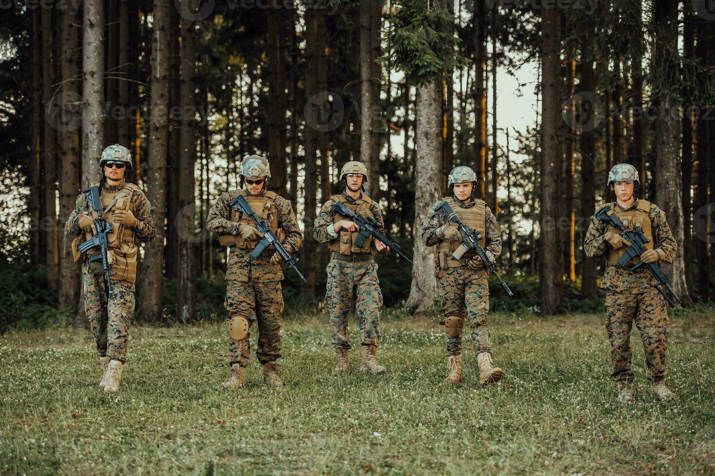 Soldier fighters standing together with guns. Group portrait of US army elite members, private military company servicemen, anti terrorist squad photo