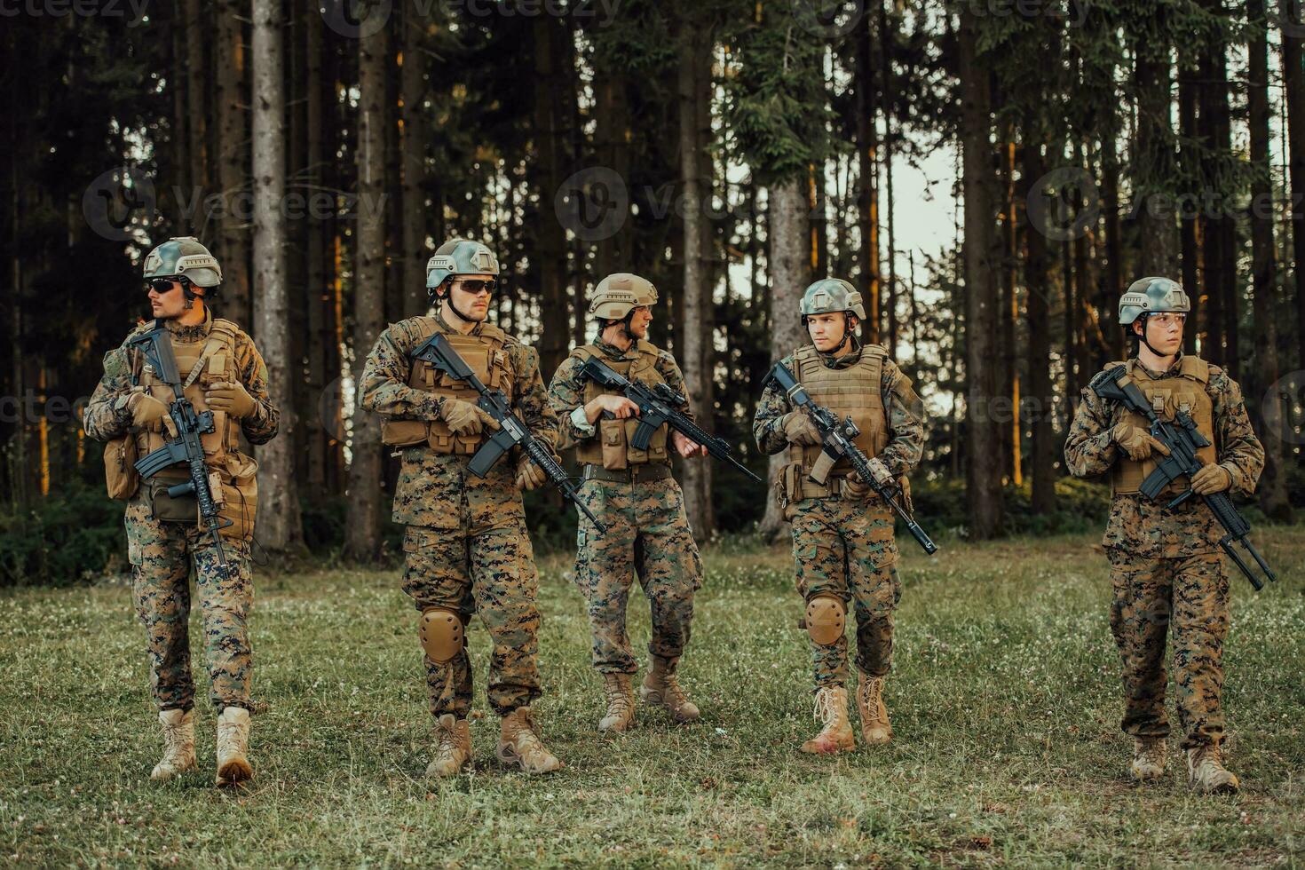 Soldier fighters standing together with guns. Group portrait of US army elite members, private military company servicemen, anti terrorist squad photo