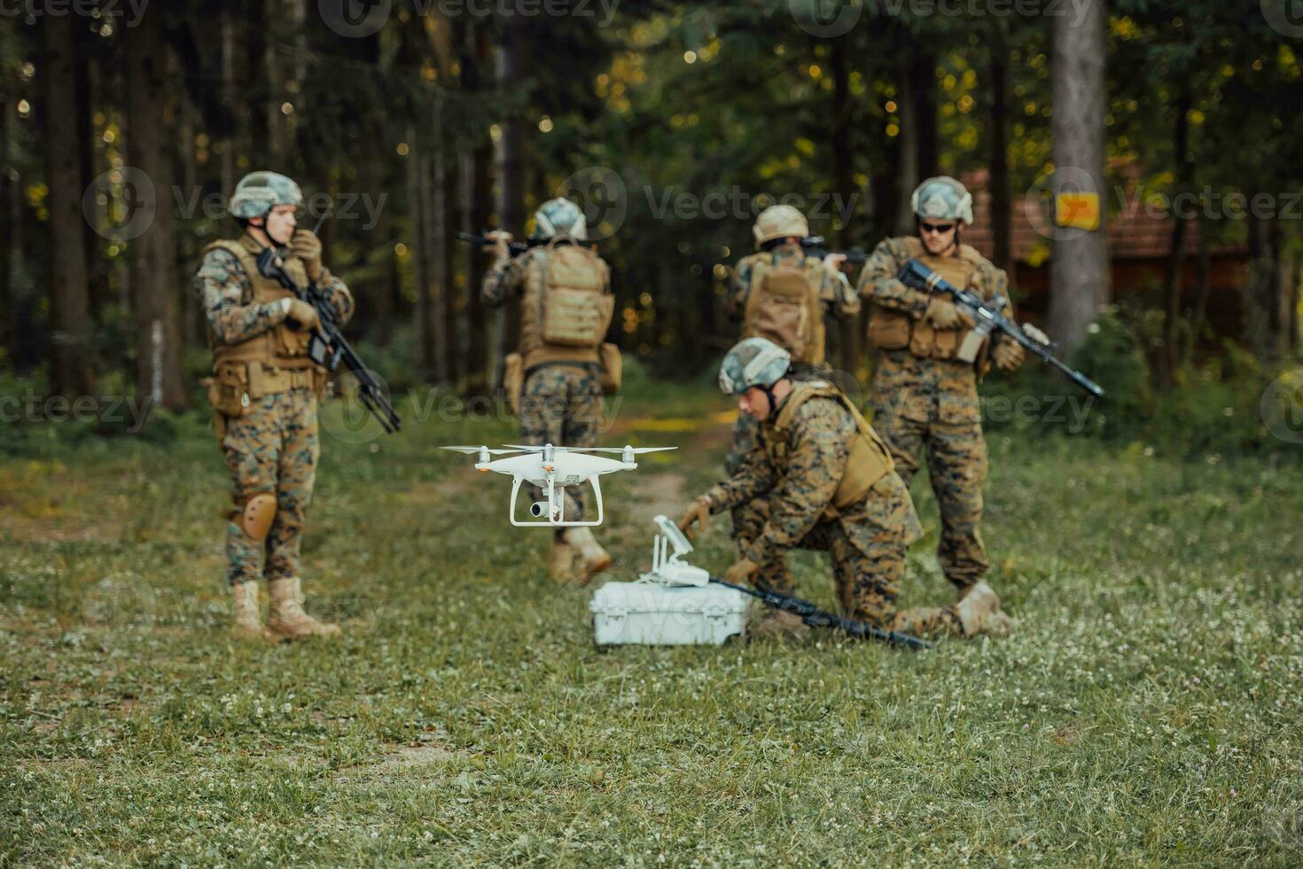 Modern Warfare Soldiers Squad are Using Drone for Scouting and Surveillance During Military Operation in the Forest. photo