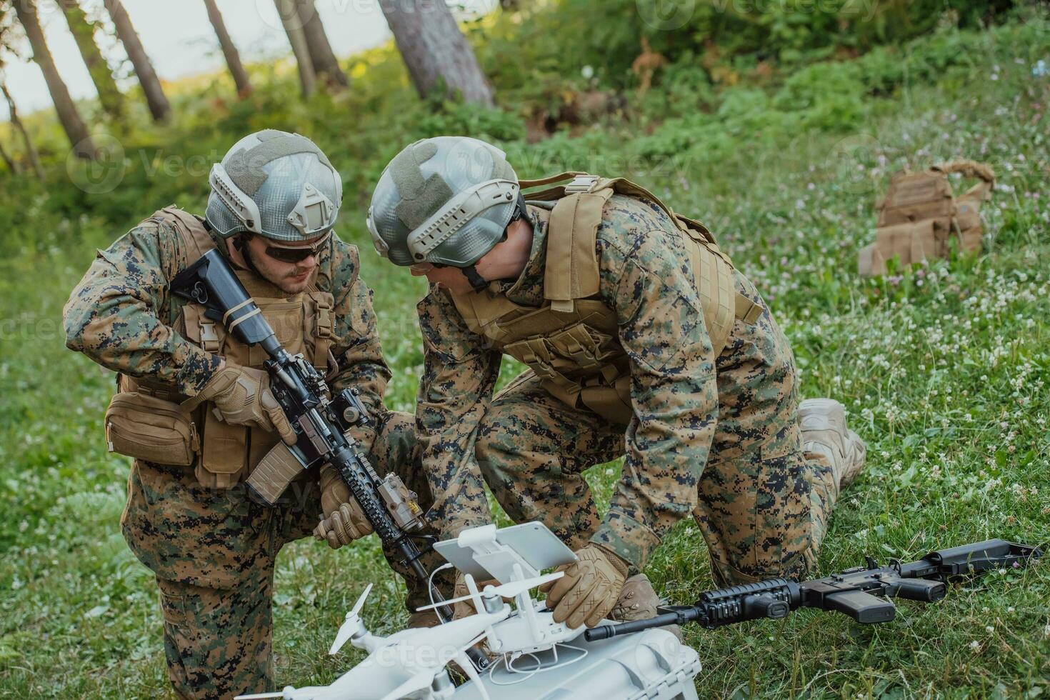 Modern Warfare Soldiers Squad are Using Drone for Scouting and Surveillance During Military Operation in the Forest. photo