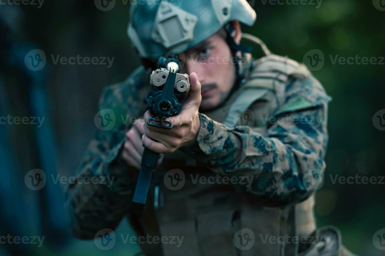 A modern warfare soldier on war duty in dense and dangerous forest areas. Dangerous military rescue operations photo