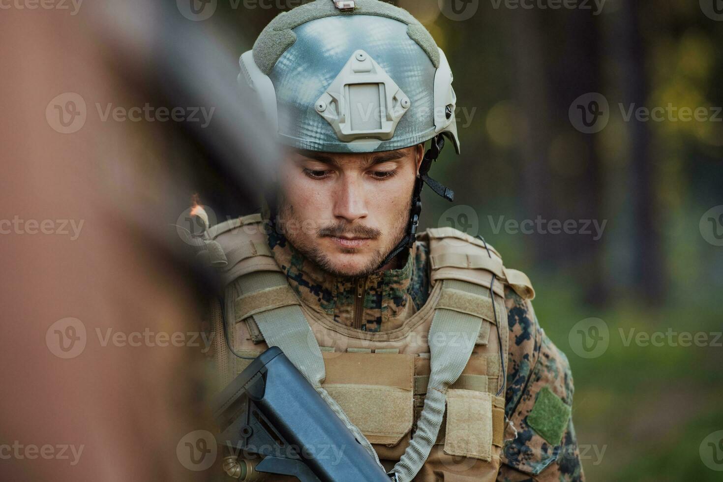 Soldier portrait with protective army tactical gear and weapon having a break and relaxing photo