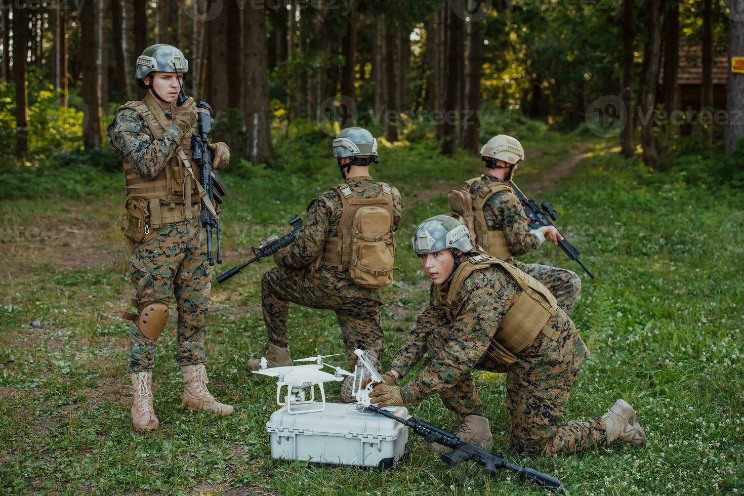 Modern Warfare Soldiers Squad are Using Drone for Scouting and Surveillance During Military Operation in the Forest. photo