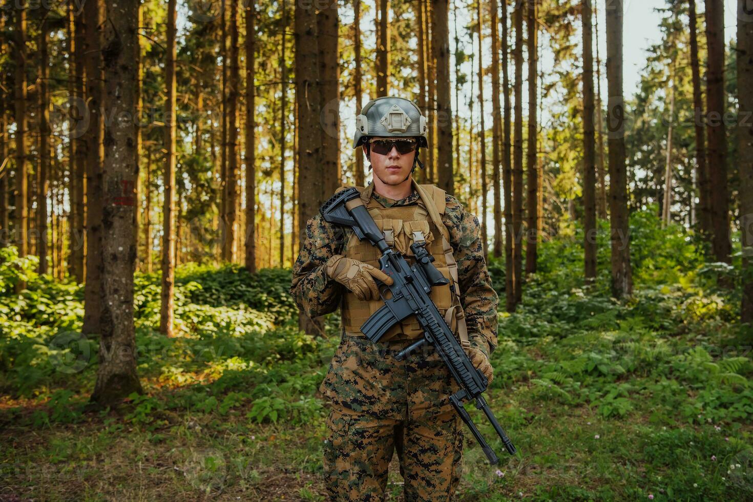 A modern warfare soldier on war duty in dense and dangerous forest areas. Dangerous military rescue operations photo