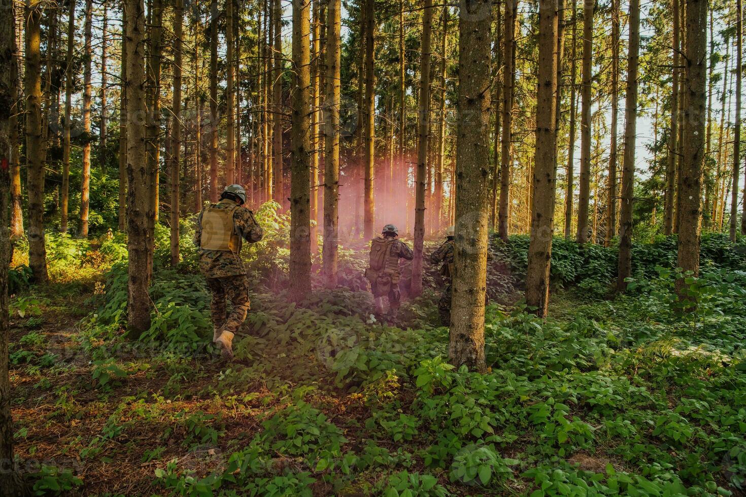 A group of modern warfare soldiers is fighting a war in dangerous remote forest areas. A group of soldiers is fighting on the enemy line with modern weapons. The concept of warfare and military conflicts photo