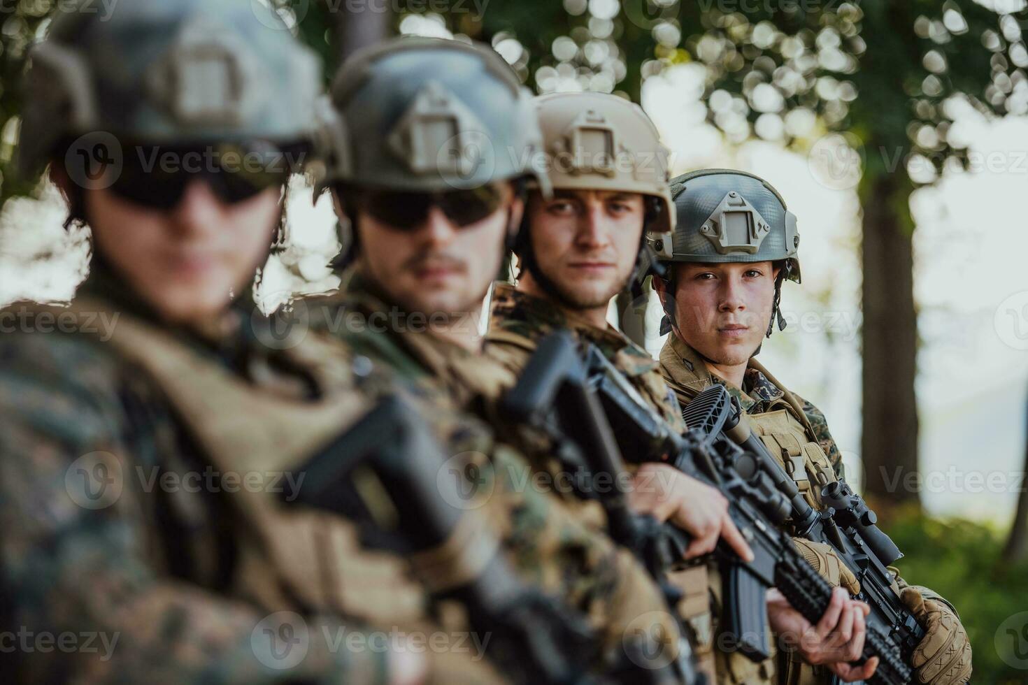 Soldier fighters standing together with guns. Group portrait of US army elite members, private military company servicemen, anti terrorist squad photo