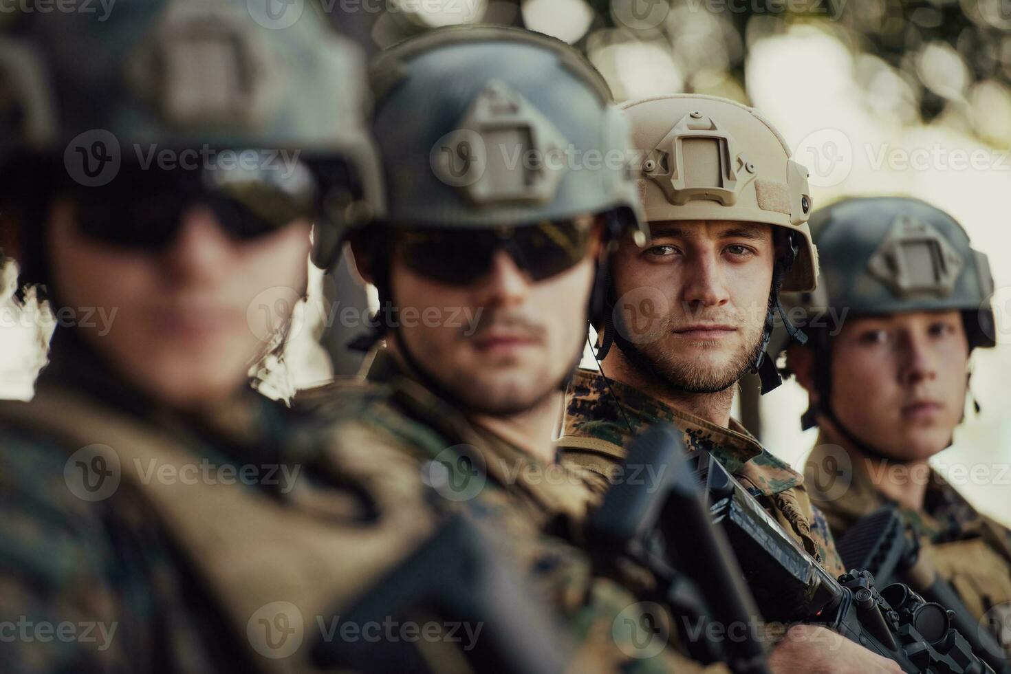 Soldier fighters standing together with guns. Group portrait of US army elite members, private military company servicemen, anti terrorist squad photo