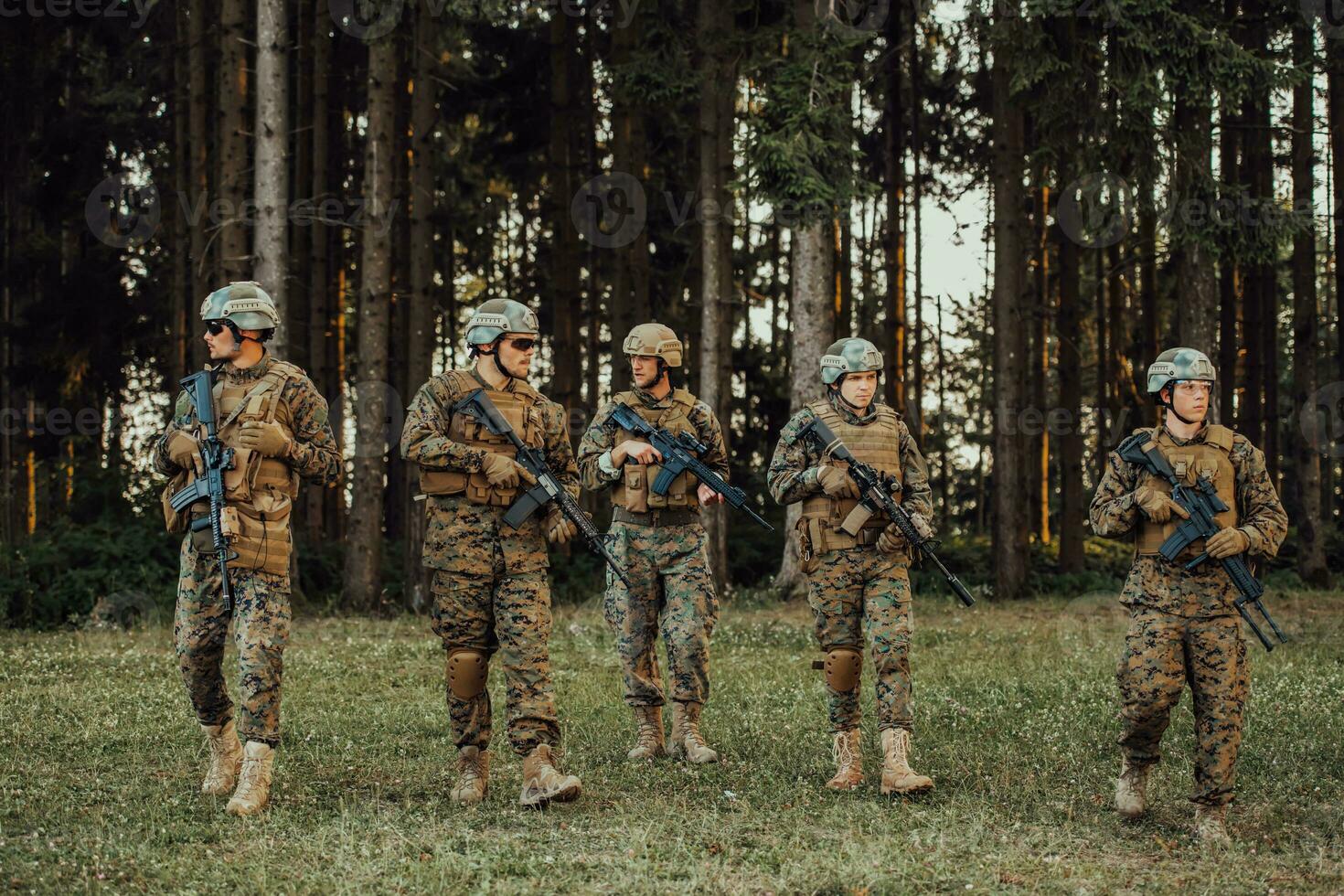 Soldier fighters standing together with guns. Group portrait of US army elite members, private military company servicemen, anti terrorist squad photo