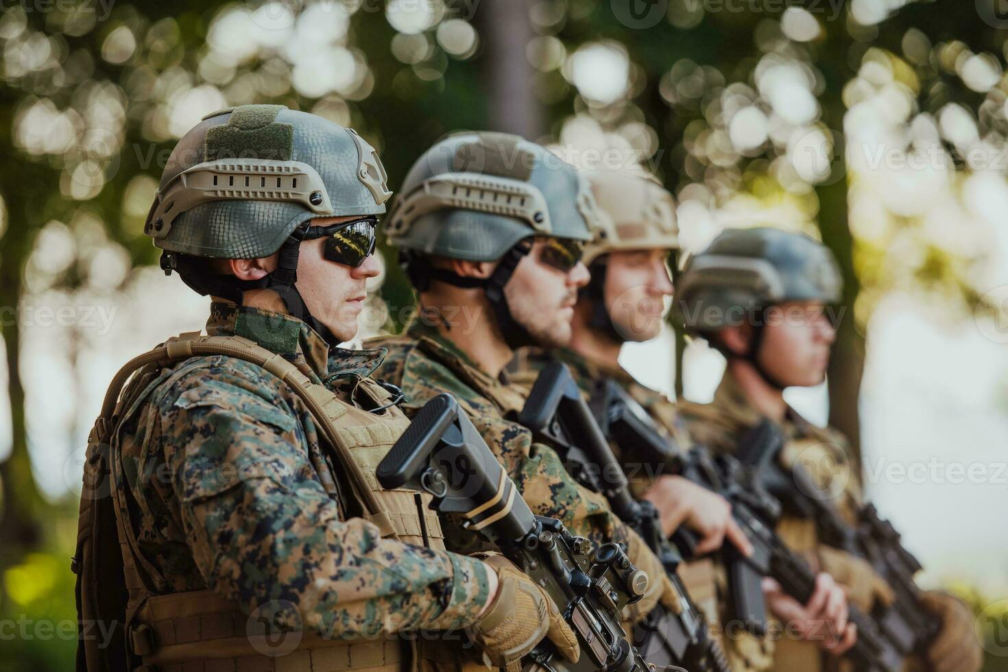 Soldier fighters standing together with guns. Group portrait of US army elite members, private military company servicemen, anti terrorist squad photo