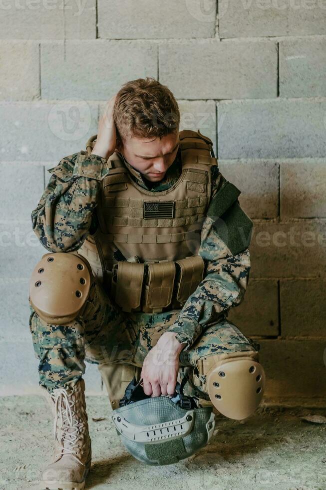 Upset soldier has psychological problems holding his head photo