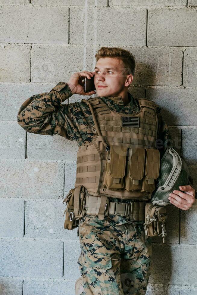 Soldier using smartphone and calling home family and friends photo