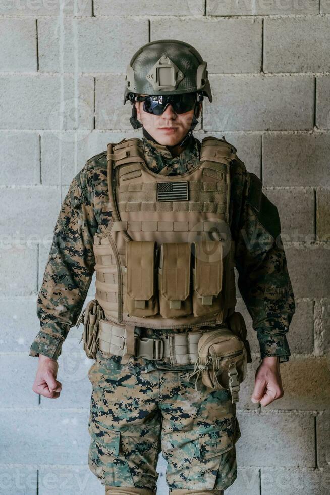 Soldier preparing tactical protective and communication gear for action battle photo