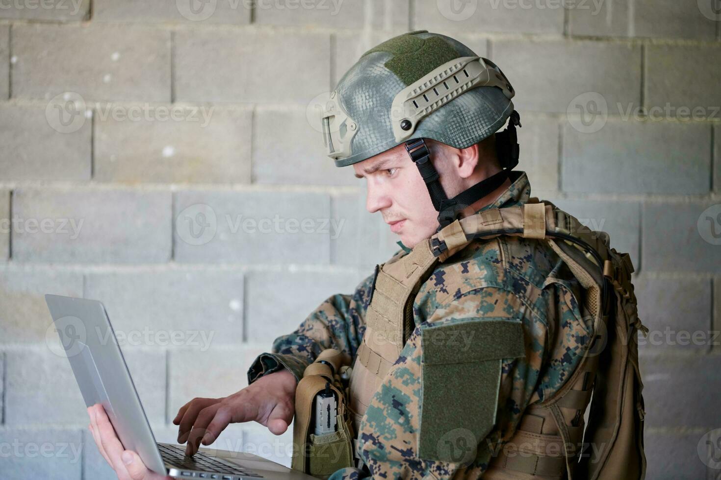 soldier using laptop computer photo