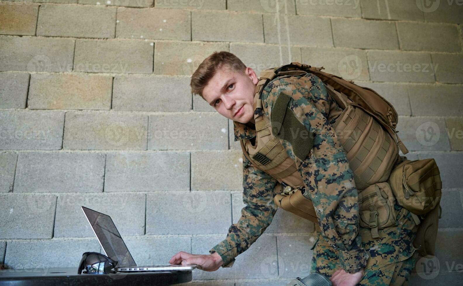 soldier using laptop computer photo
