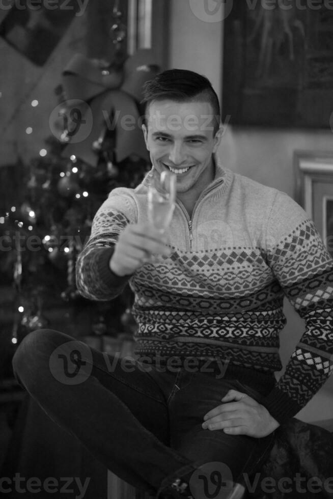 Happy young man with a glass of champagne photo