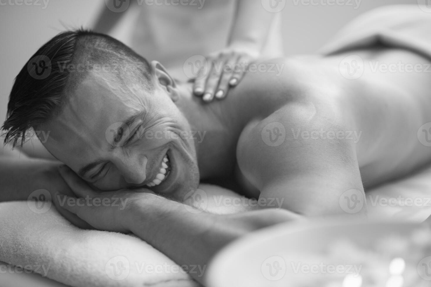 young man having a back massage photo