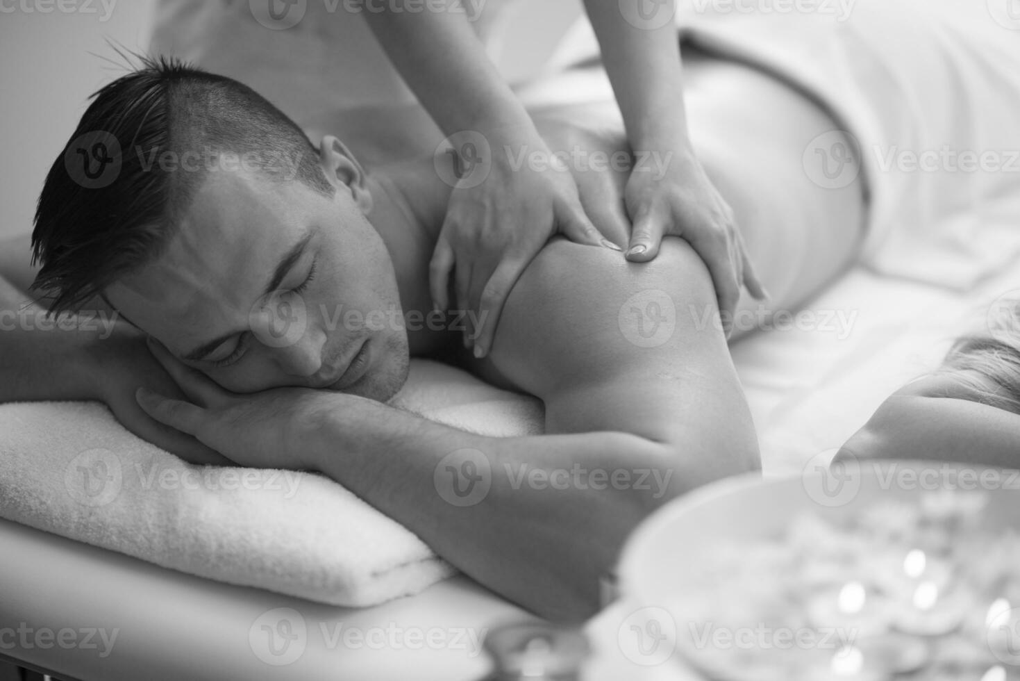 young man having a back massage photo