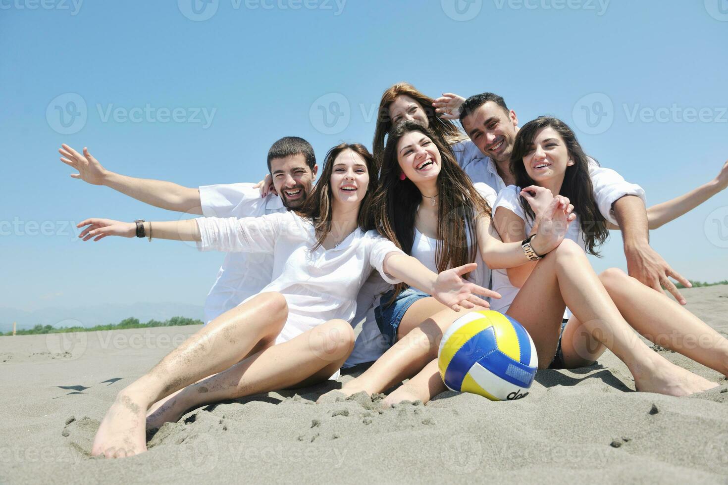 Group of happy young people in have fun at beach photo