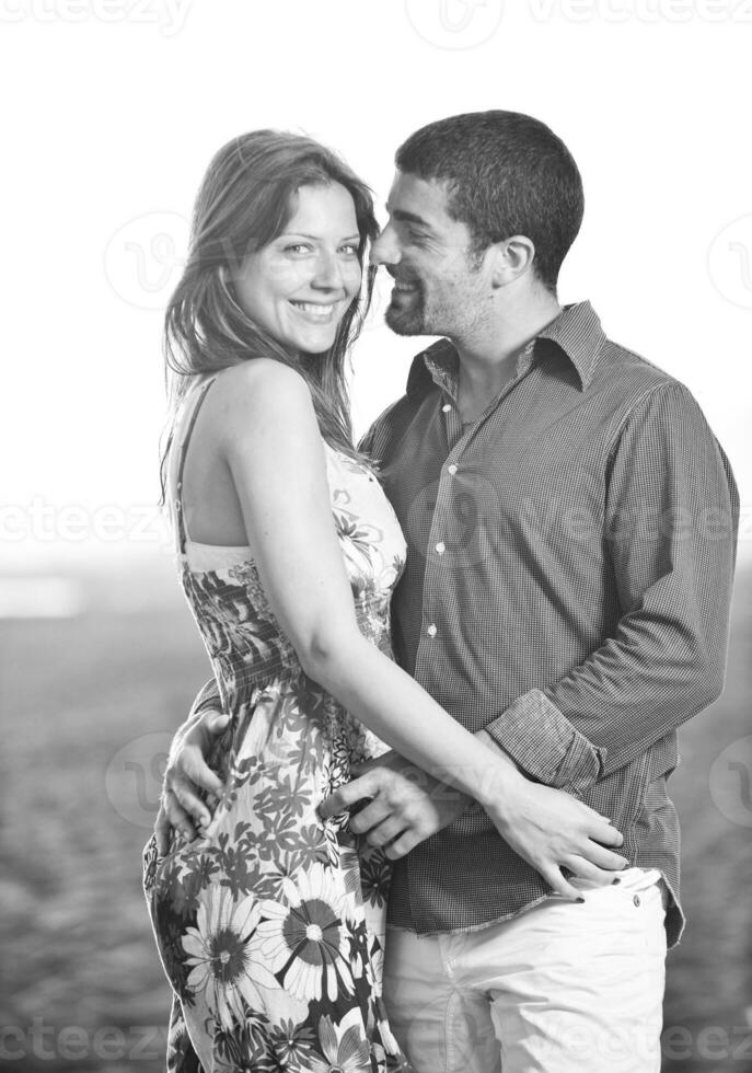 happy young couple have romantic time on beach photo