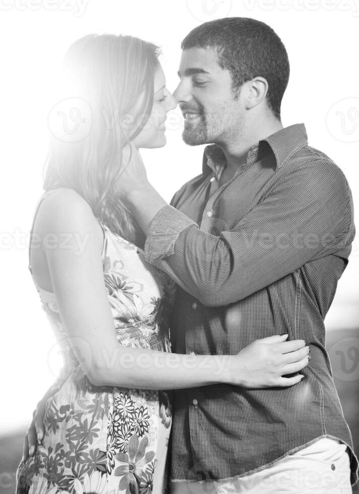 happy young couple have romantic time on beach photo