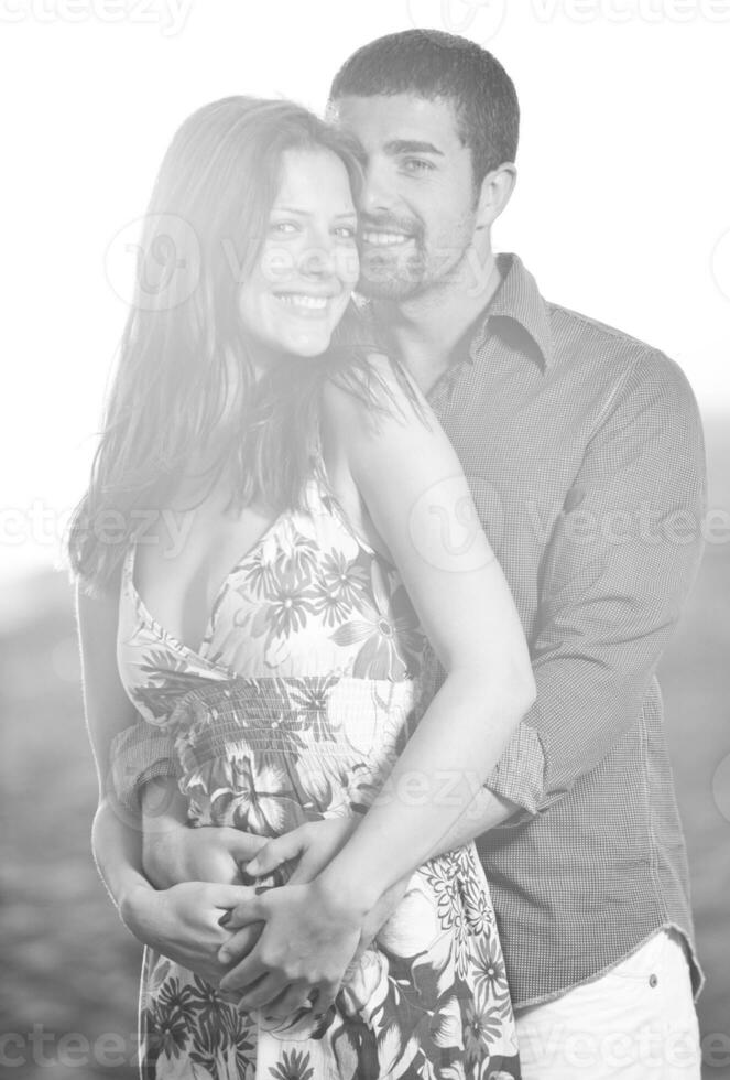 happy young couple have romantic time on beach photo