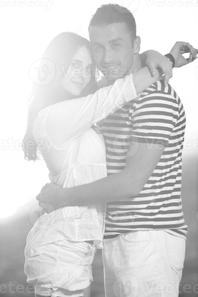 happy young couple have romantic time on beach photo