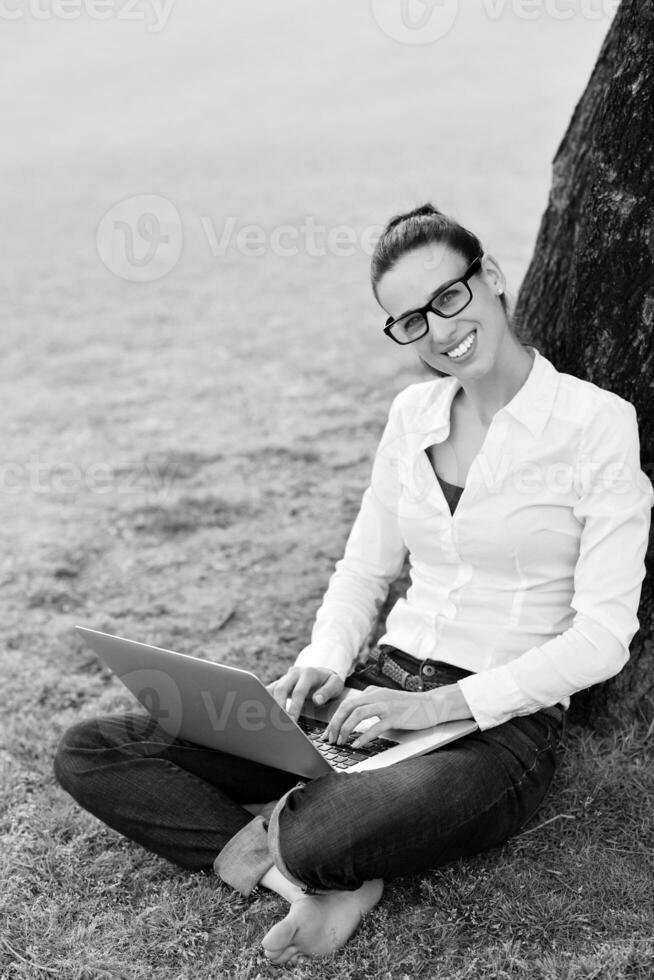 woman with laptop in park photo