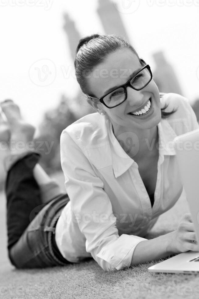 woman with laptop in park photo