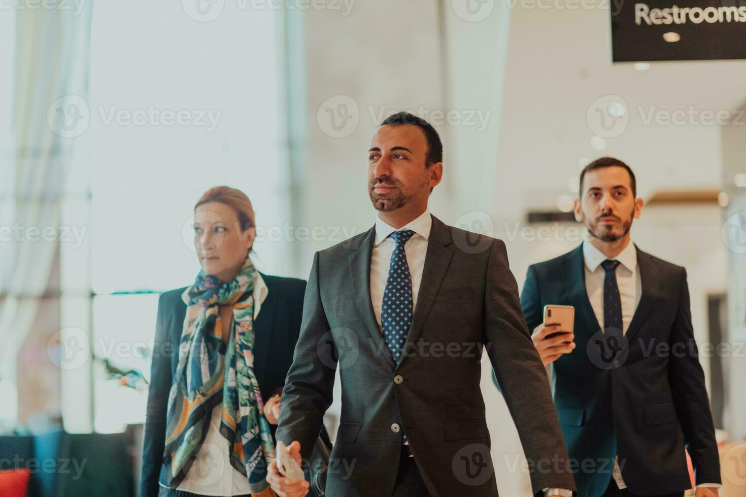 Photo of a business team in suits walking in a modern corporation. Successful business team. Selective focus