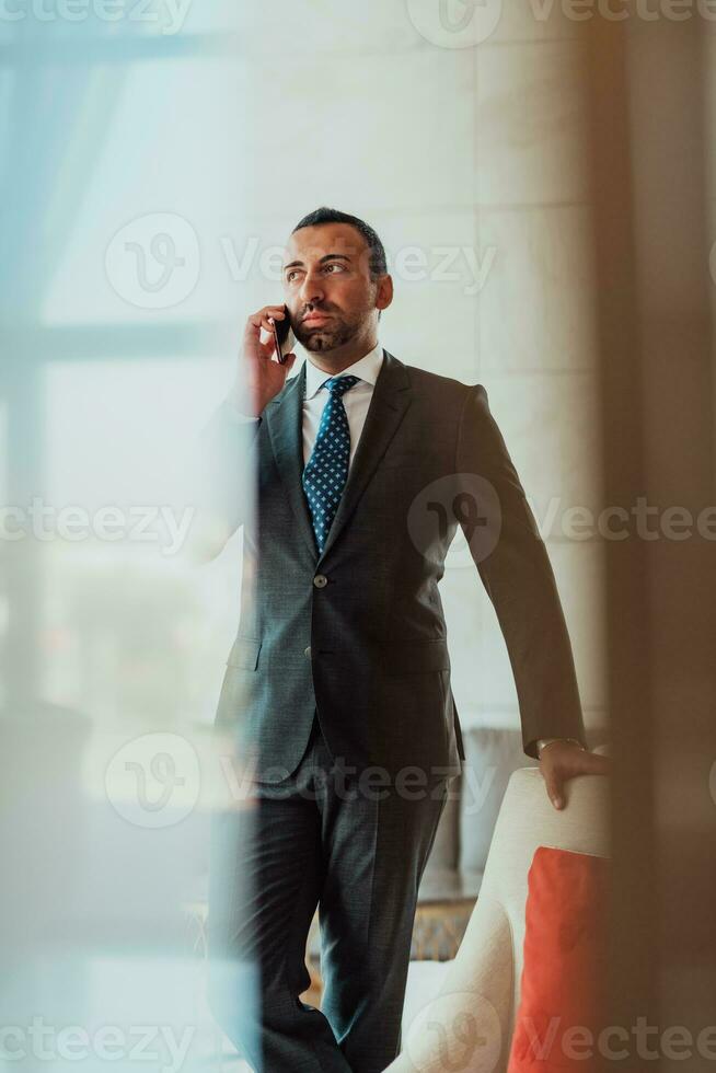Photo of a businessman in a modern company using a smartphone. Selective focus