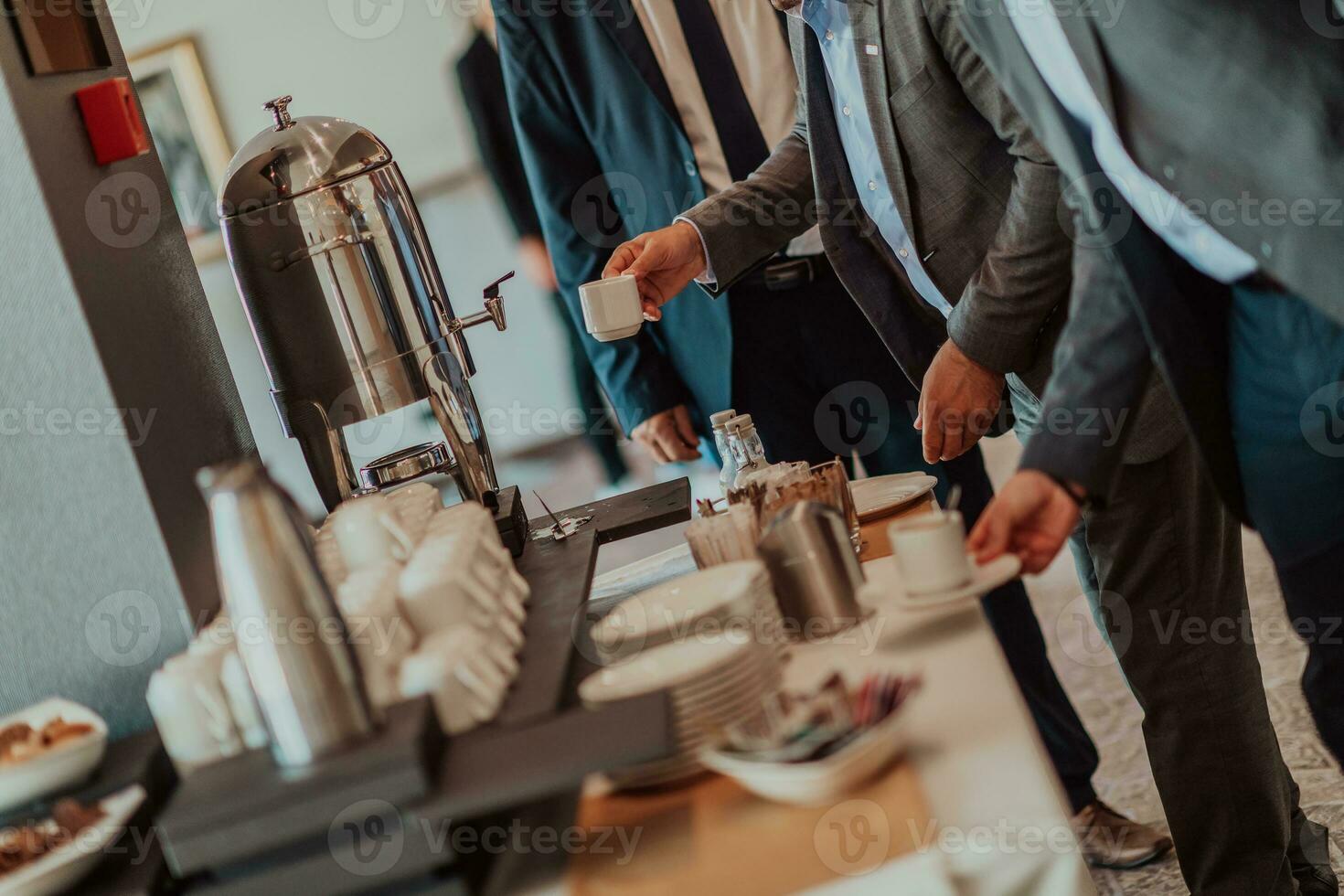 Close-up photo of businessmen serving themselves in a modern hotel during a dinner party. Selective focus