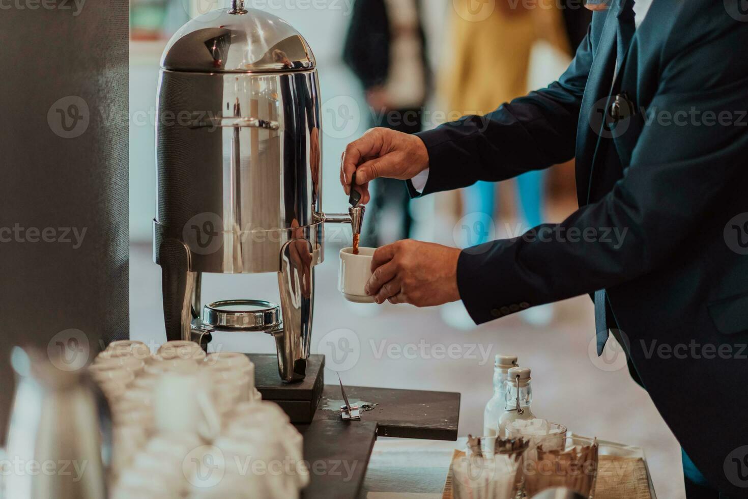 Close-up photo of businessmen serving themselves in a modern hotel during a dinner party. Selective focus