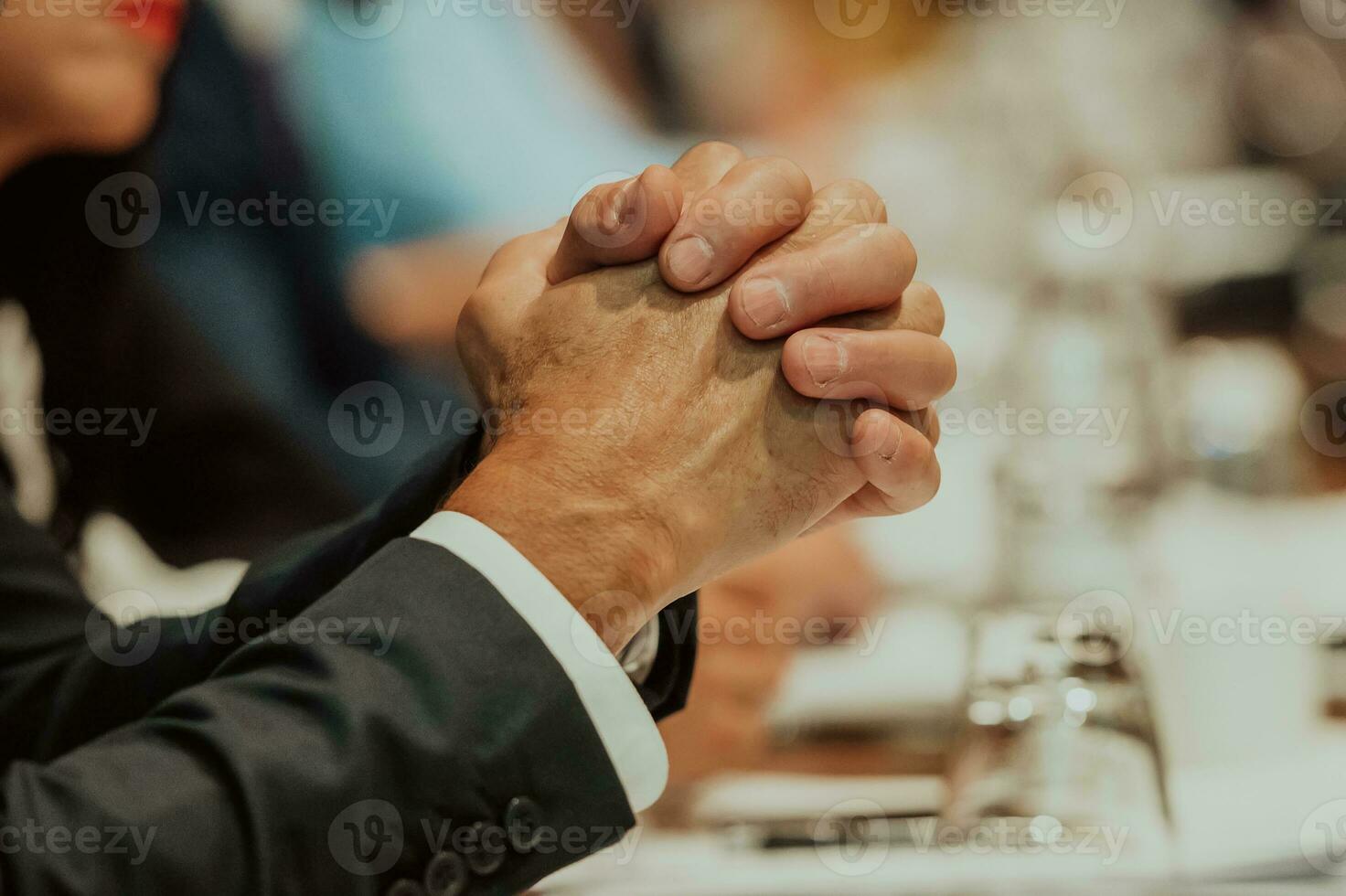 Close-up photo of businessmen who are at a meeting and business meeting in a modern hall