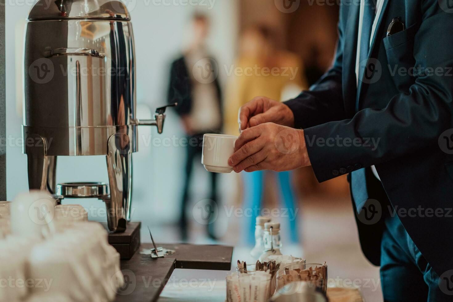 Close-up photo of businessmen serving themselves in a modern hotel during a dinner party. Selective focus