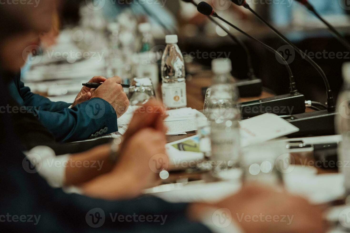 Close-up photo of businessmen who are at a meeting and business meeting in a modern hall