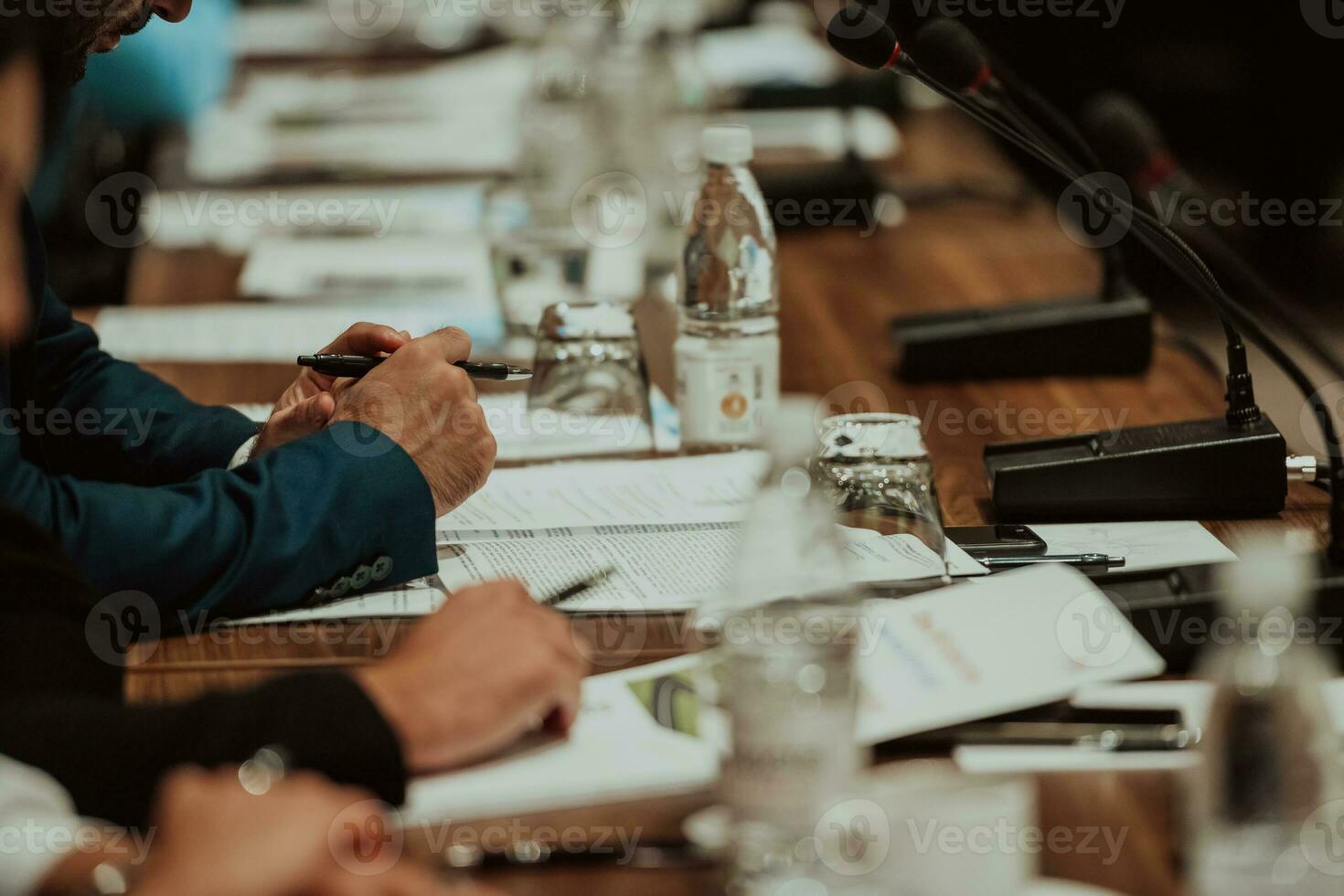 Close-up photo of businessmen who are at a meeting and business meeting in a modern hall