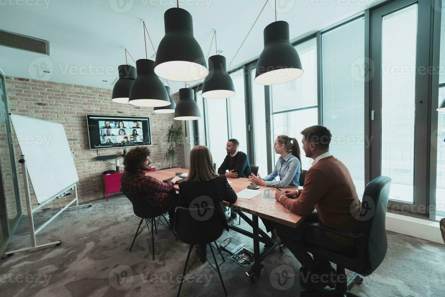 Successful team. Group of young multi-ethnic business people working and communicating together in creative office. Selective focus photo