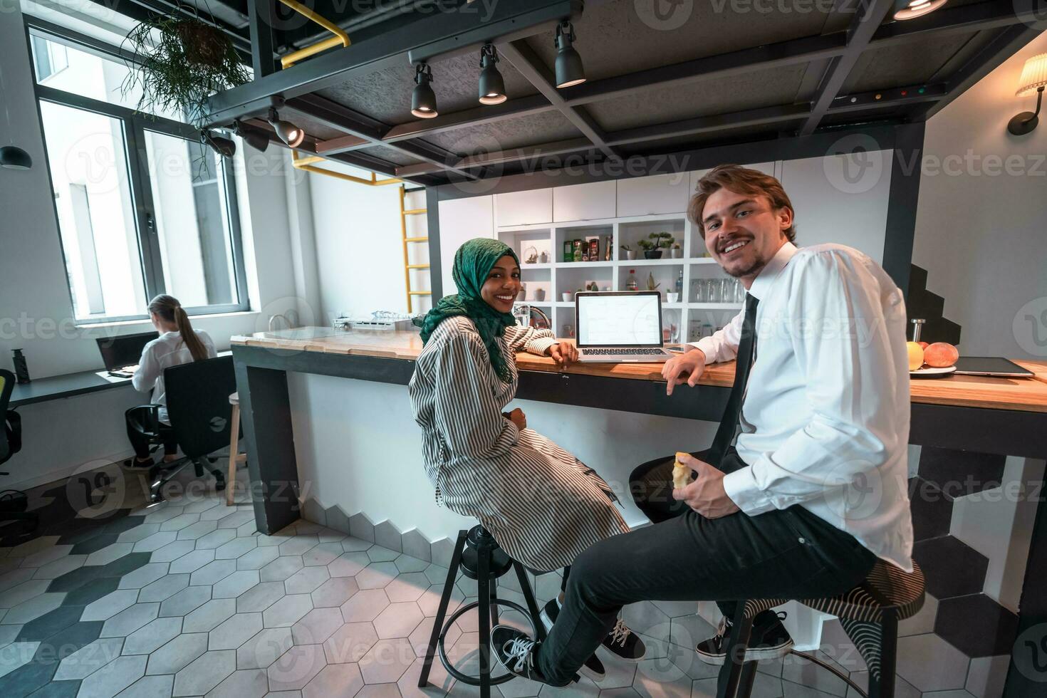 International multicultural business team.A young business man and woman sit in a modern relaxation space and talk about a new business. photo