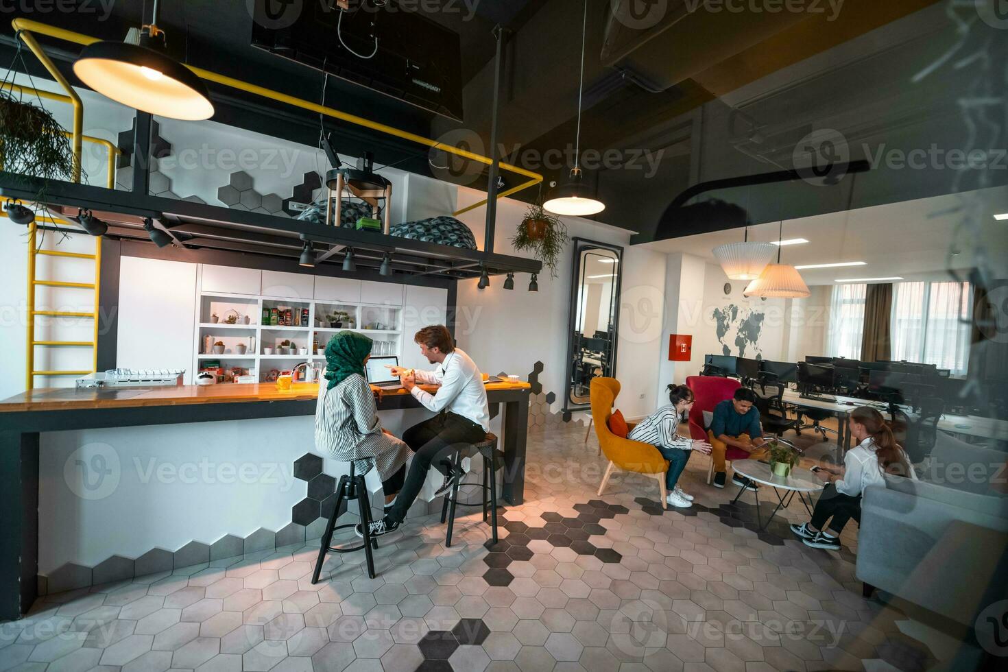 Group of casual multiethnic business people taking break from the work doing different things while enjoying free time in relaxation area at modern open plan startup office photo