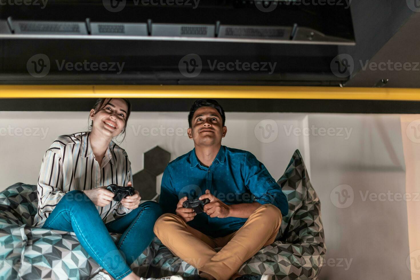 Work hard play hard. Workers Playing computer games man against woman during break in relaxation area at creative startup Office photo