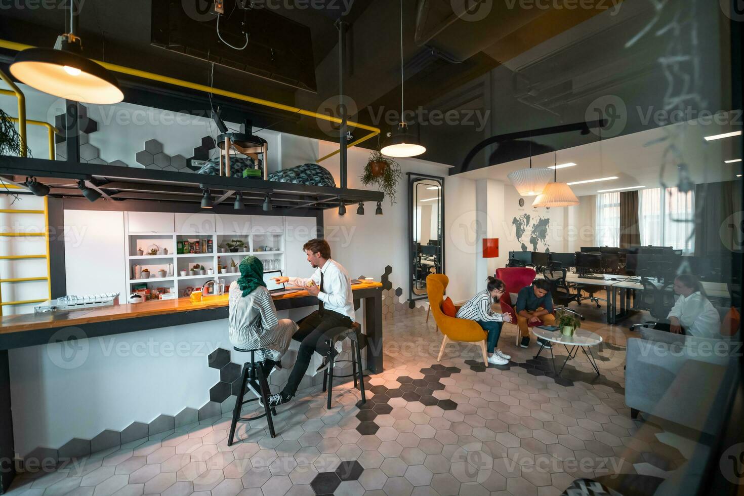 Group of casual multiethnic business people taking break from the work doing different things while enjoying free time in relaxation area at modern open plan startup office photo