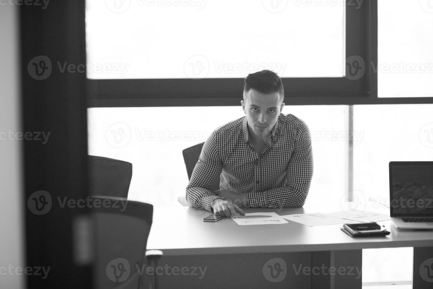 young businessman at his desk in office photo