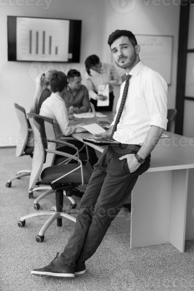 joven hombre de negocios con tableta en la sala de reuniones de la oficina foto