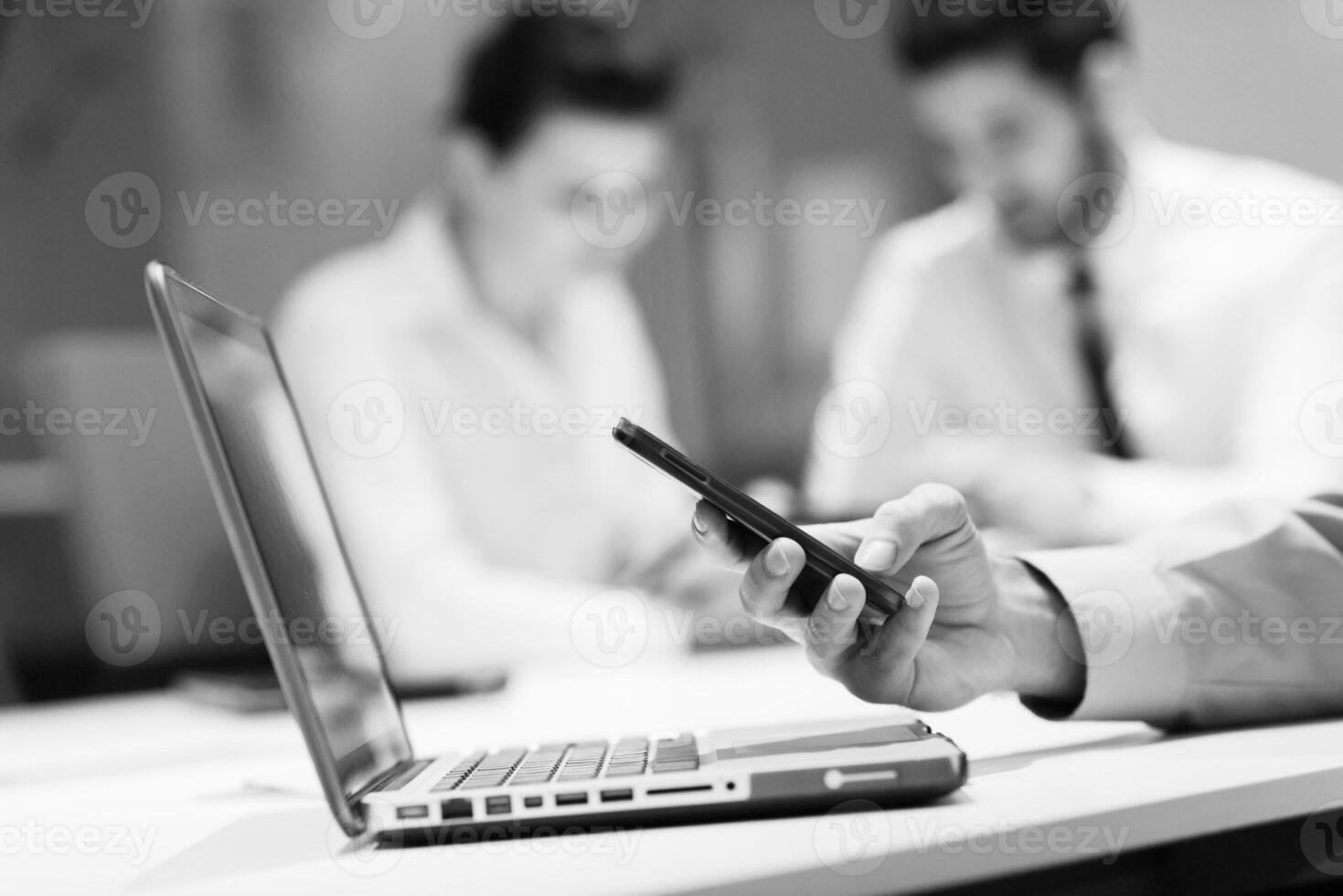 close up of  businessman hands  using smart phone on meeting photo