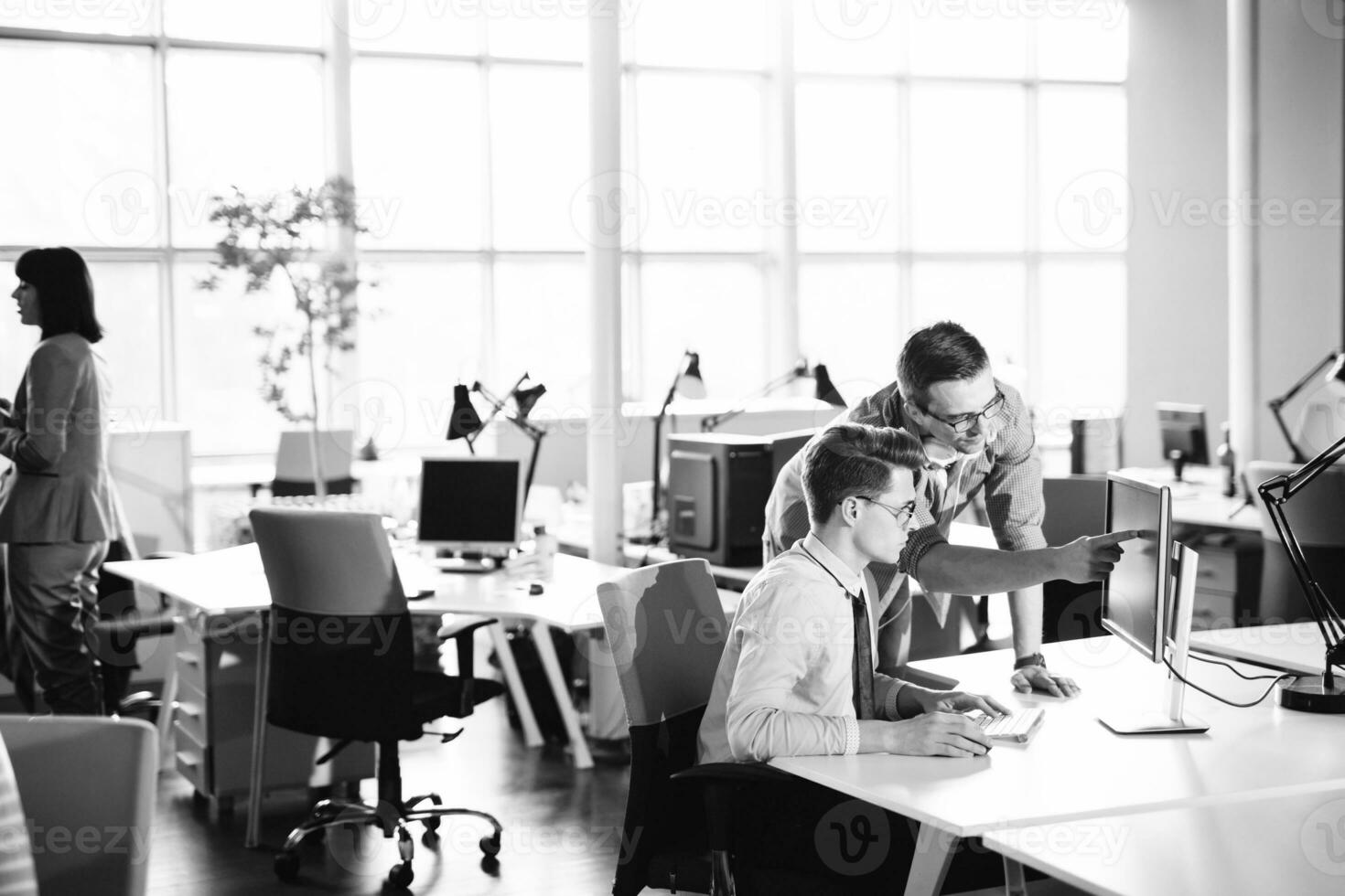 Two Business People Working With computer in office photo