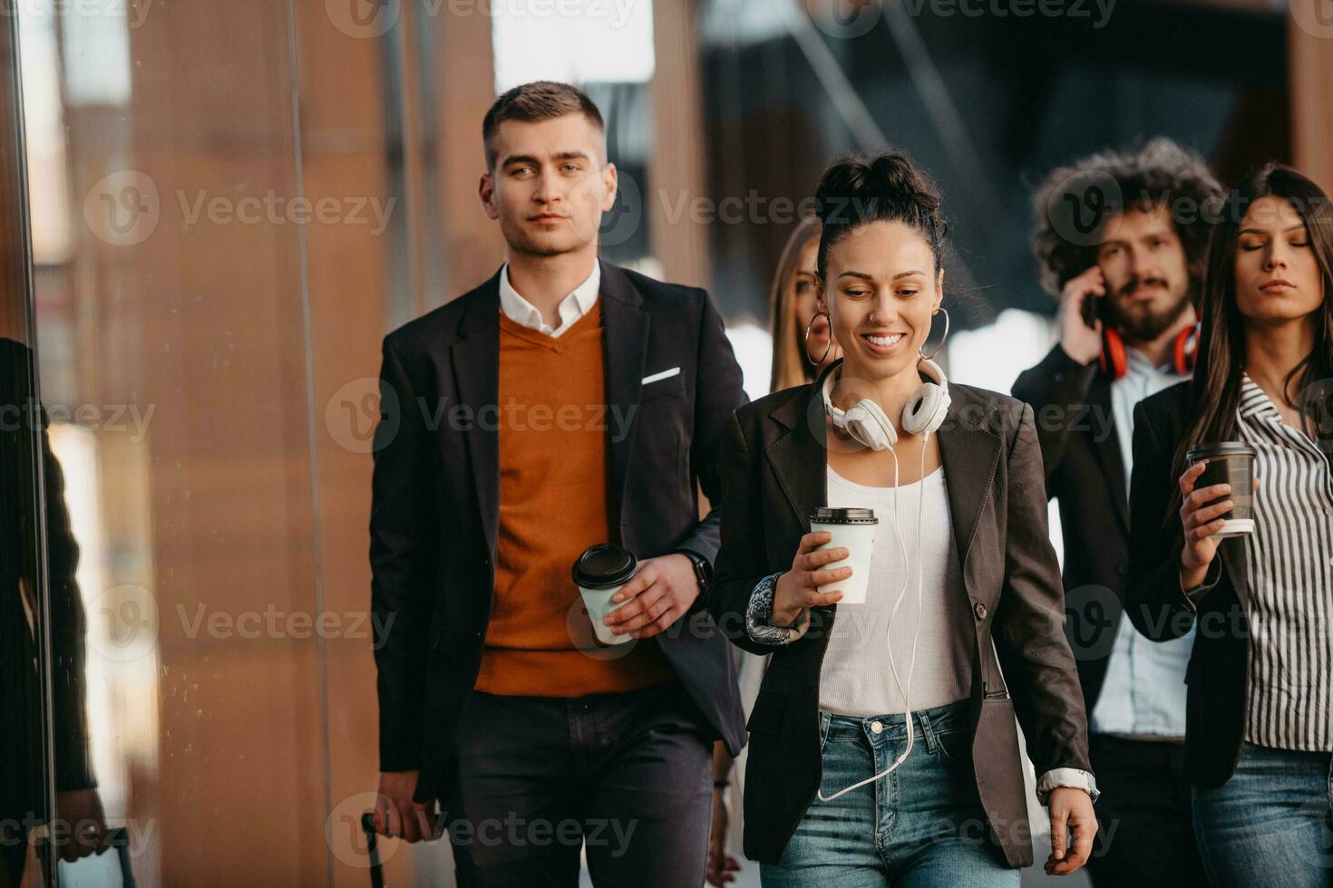 Travelers business team of colleagues walking and talking on modern urban city streets. People on out of the office on break. photo