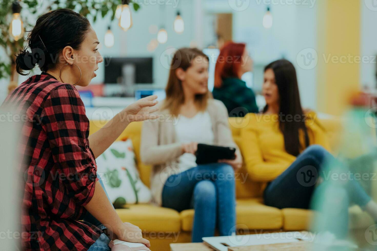 Group of multi-ethnic colleagues working on desktop computers, laptop and sharing their ideas in a modern office space.Young influencers work on online marketing projects. photo