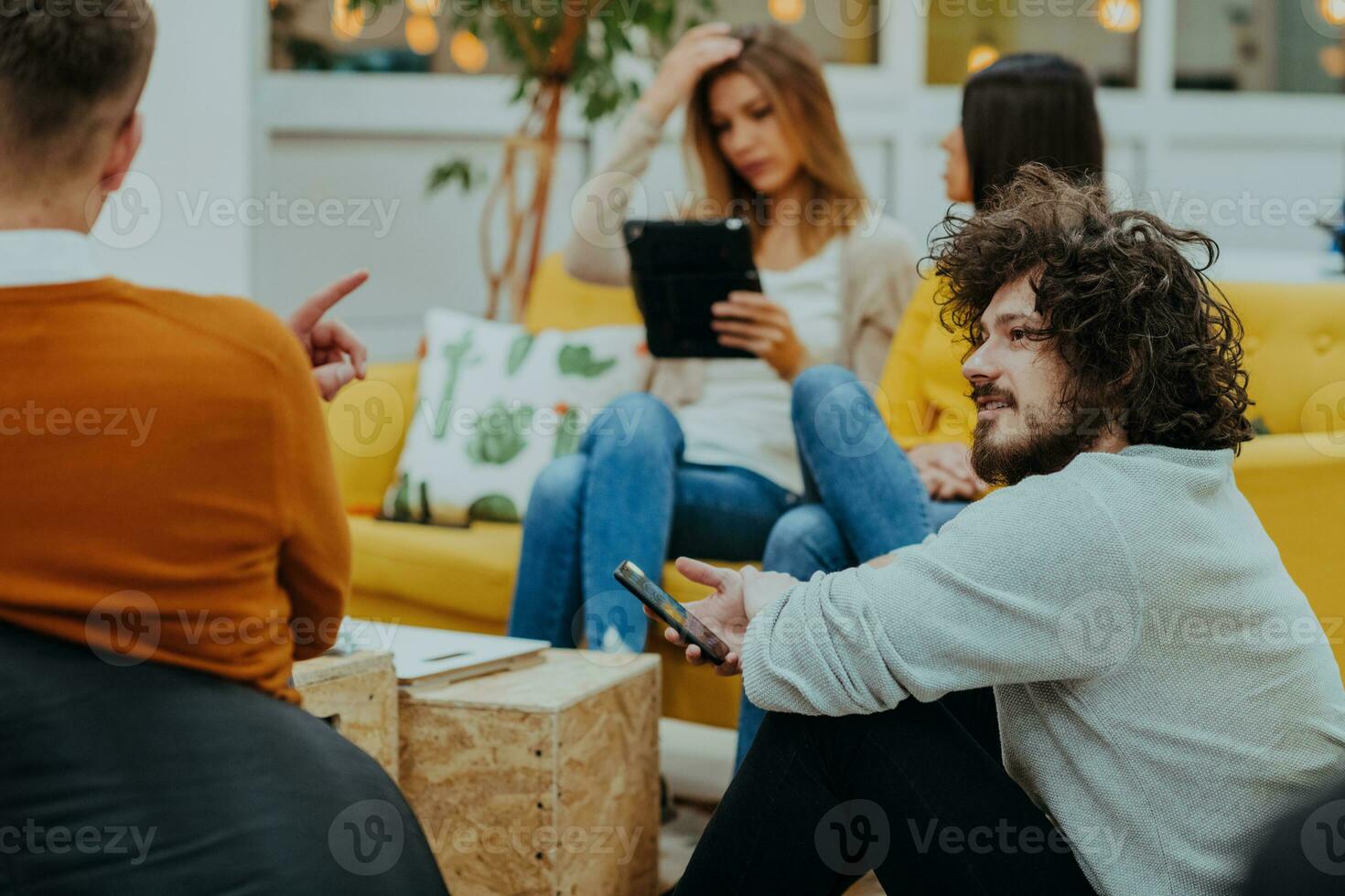 Group of multi-ethnic colleagues working on desktop computers, laptop and sharing their ideas in a modern office space.Young influencers work on online marketing projects. photo