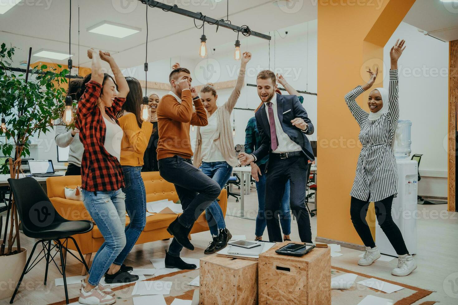 Group of business people throwing paper in air at modern startup office, team success and job done concept photo